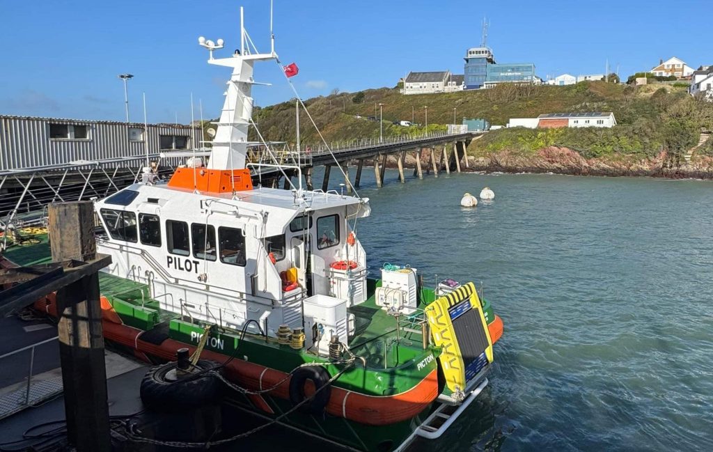 Milford Haven Port Authority pilot boat Picton with Zelim's SWIFT recovery system installed, docked under a clear blue sky.