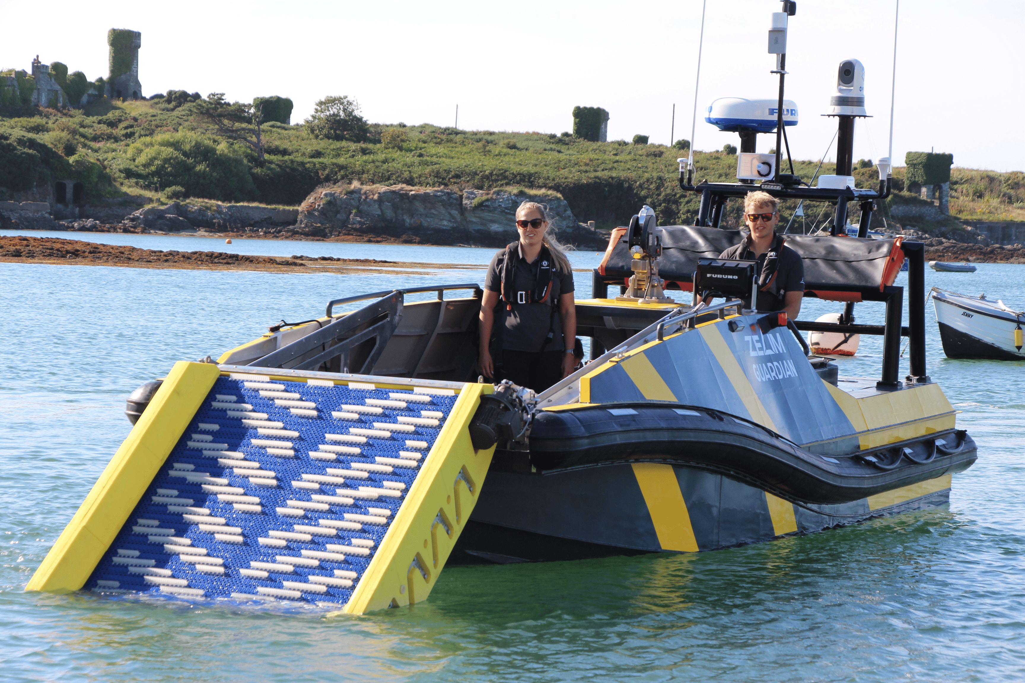 Sam Mayall, CEO of Zelim, and Laura, Engineering Operations Manager, standing onboard the Guardian vessel, a state-of-the-art uncrewed rescue craft designed for maritime safety.